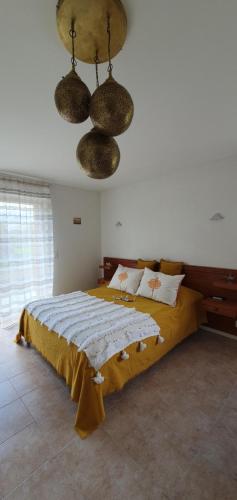 a bedroom with a large bed and a ceiling at L'Aurosée in Savièse