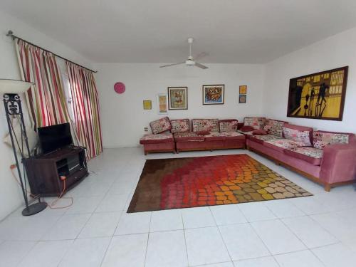 a living room with a couch and a tv at فيلا مارينا٥ على البحيره ٥ غرف in El Alamein
