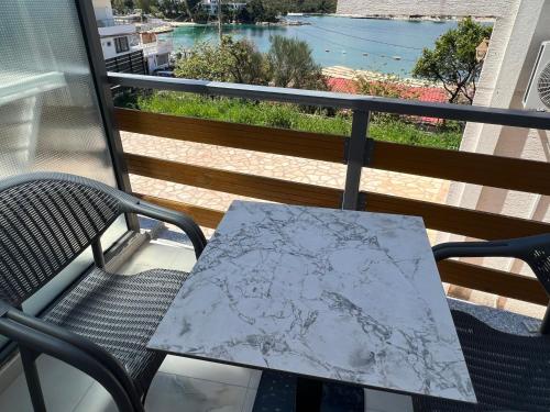a table on a balcony with a map on it at Ion Sea View in Ksamil