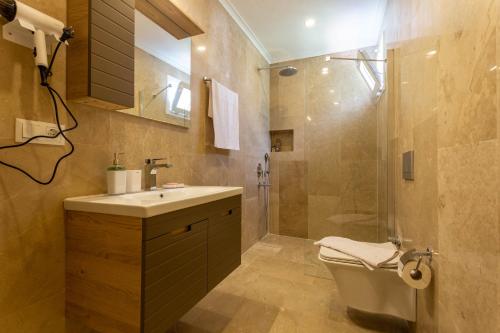 a bathroom with a toilet and a sink and a shower at Villa Marine Luxury in Kas