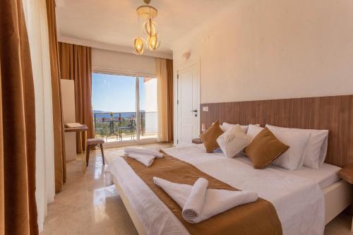 a bedroom with a large bed with a large window at Villa Marine Luxury in Kas