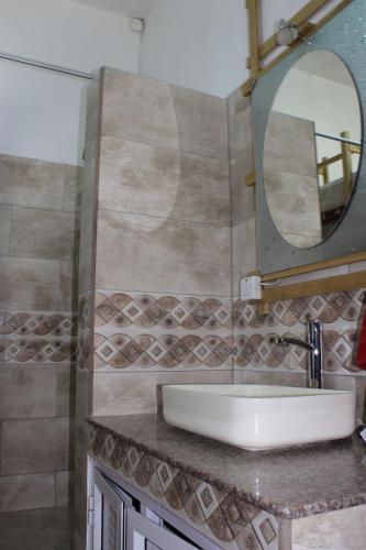 a bathroom with a sink and a mirror at LeBovallon B&B in Mahébourg
