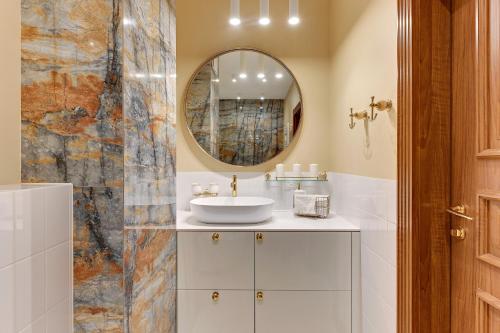 a bathroom with a sink and a mirror at Granaria by Welcome Apartment in Gdańsk