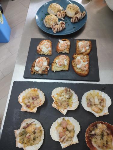 a table topped with different types of food on plates at B&B Giardino Isabella in Palagiano
