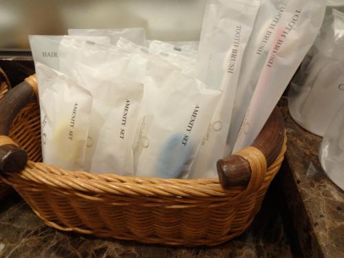 a basket filled with white books on a counter at Kyu Karuizawa Hotel Otowa No Mori in Karuizawa