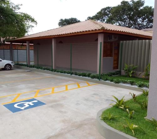 a parking lot with a handicapped sign in front of a house at Hotel do Carmo in Piracuruca