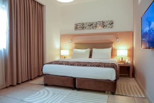 a bedroom with a large bed in a room at Toledo Amman Hotel in Amman