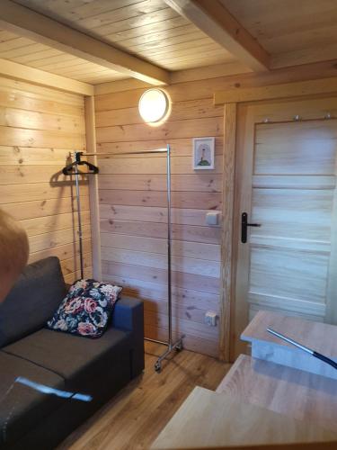 a living room with a couch and a glass door at Szteklin os. Nowe in Szteklin