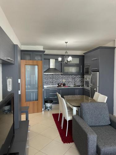 a kitchen and living room with a table and chairs at City Center With Lake View One Bedroom Apartment in Pogradec