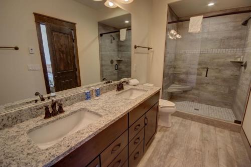 a bathroom with two sinks and a shower at River Run Townhomes 63 in Keystone