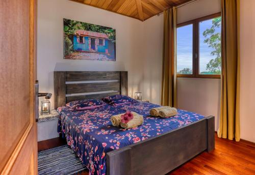 a bedroom with a bed with two pillows on it at CHALETS TIKINOU in Saint-Pierre