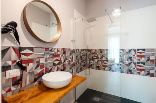 a bathroom with a sink and a mirror at Lemon's Apartment in Elmas