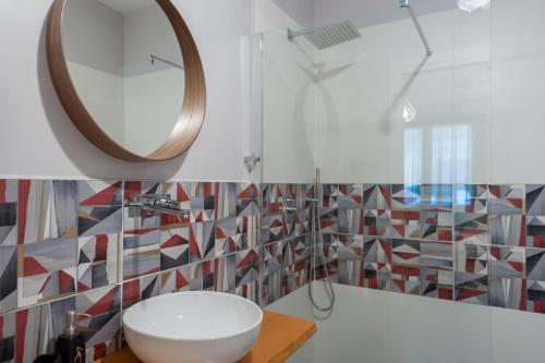 a bathroom with a sink and a mirror at Lemon's Apartment in Elmas