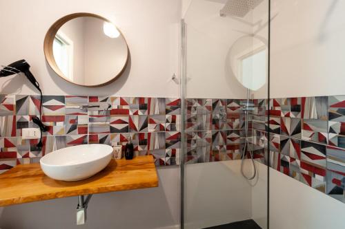 a bathroom with a sink and a mirror at Lemon's Apartment in Elmas