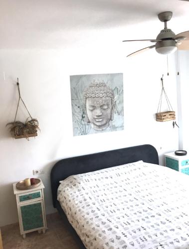 a bedroom with a bed with a statue on the wall at 4 bed house, Private Pool near Beach in Burriana