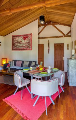 a living room with a table and chairs and a couch at CHALETS TIKINOU in Saint-Pierre