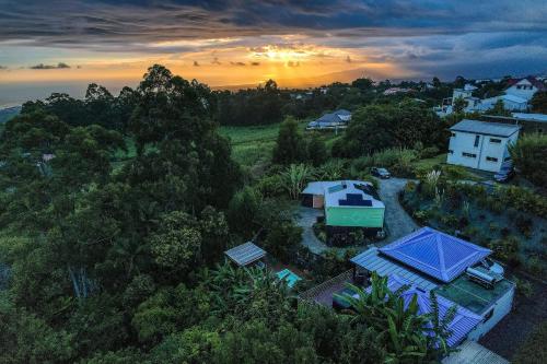 an overhead view of a house with trees and a sunset at CHALETS TIKINOU in Saint-Pierre