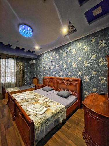 a bedroom with a large bed in a room at Nurafshon Boutique in Bukhara