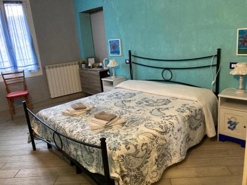 a bedroom with a bed with a blue wall at L'Incantesimo in Triora