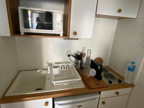 a kitchen counter with a microwave and a mixer at Appartement jusqu'à 4 personnes in Luchon