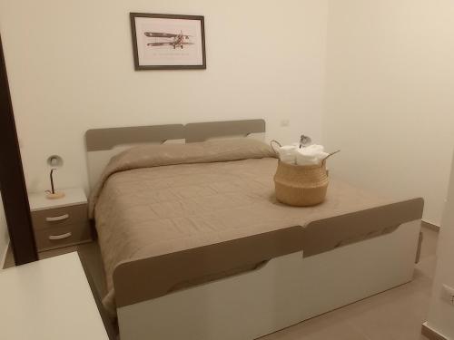 a bedroom with a bed with a basket on it at Nonna Sicula in Agrigento