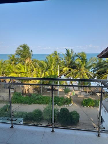 a view of the ocean from the balcony of a resort at Shanika Beach Inn in Tangalle