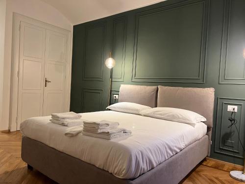 a bedroom with a large bed with books on it at Turin Central Suite in Turin