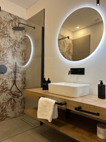 a bathroom with a sink and a mirror at Turin Central Suite in Turin