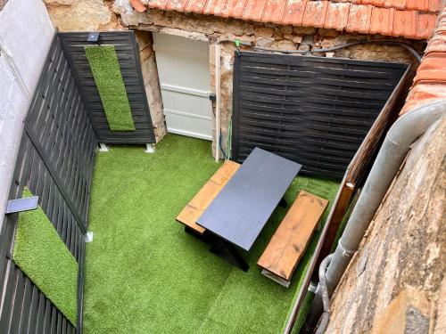 an overhead view of a table and bench on a balcony at LA PALMERAIE -wifi fibre- centre ville -PROPERTY RENTAL NM in Fontenay-le-Comte