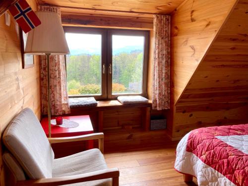 a bedroom with a window in a log cabin at Ferienhaus am Weinberg in Sankt Martin im Sulmtal