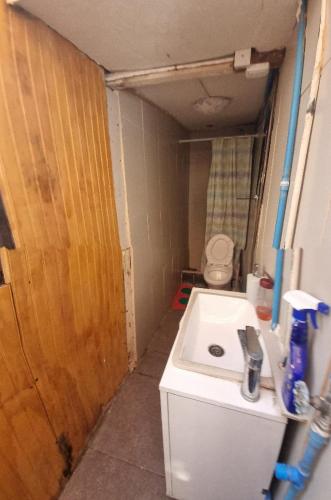 a small bathroom with a sink and a toilet at Hostal Playa Ancha in Valparaíso