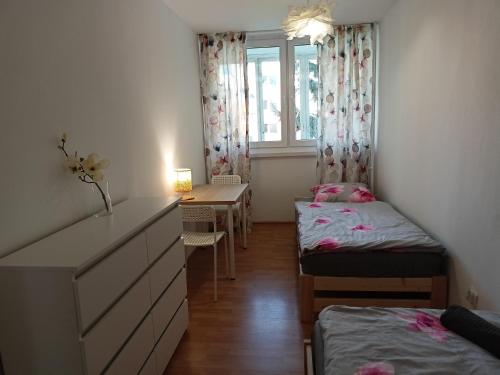 a room with two beds and a desk and a window at Lemuria Jawor pokoje in Jawor