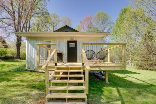 a tiny house with a staircase leading up to it at Mid-Century Modern Fayetteville Home Close to Town in Fayetteville
