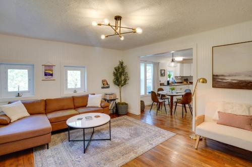 a living room with a couch and a table at Mid-Century Modern Fayetteville Home Close to Town in Fayetteville