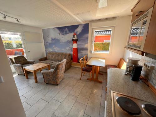 a living room with a lighthouse painted on the wall at Monika in Graal-Müritz