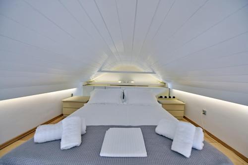 a bedroom with a bed in a small room at Pearl House in Hydra