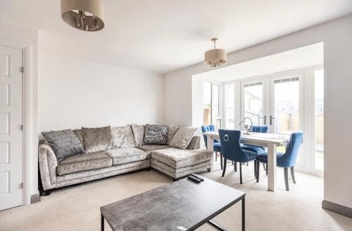 a living room with a couch and a table at Cobbeydale room in Silsden