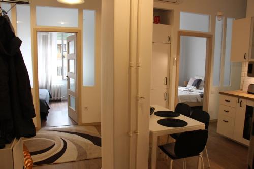 a small kitchen with a table and chairs in a room at Larix apartman in Budapest