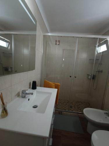 a bathroom with a sink and a shower at Casa Zeferino in Ferragudo