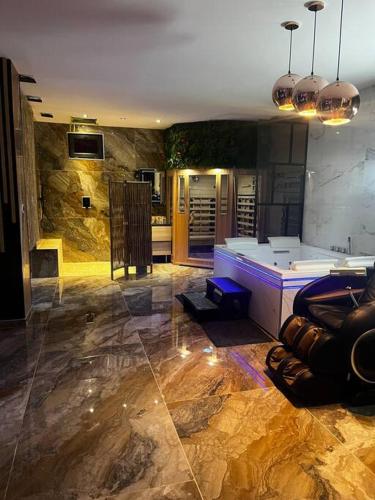 a large room with a room with a stone wall at Krystalisya Room Suite Spa Privatif Sauna Jacuzzi Siege Massant in Marseille