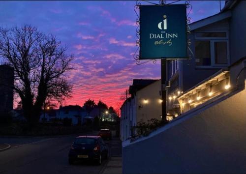 a sign for a drink inn with a sunset in the background at The Dial inn in Lamphey