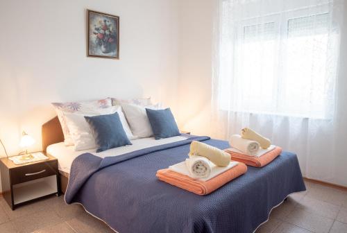 a bedroom with a large bed with towels on it at Apartment Silvana in Senj