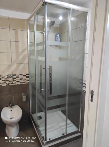 a glass shower in a bathroom with a toilet at Casa Dori in Rome
