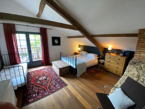 a bedroom with a bed and a dresser in a room at Domaine Du Tafiart in Sarron