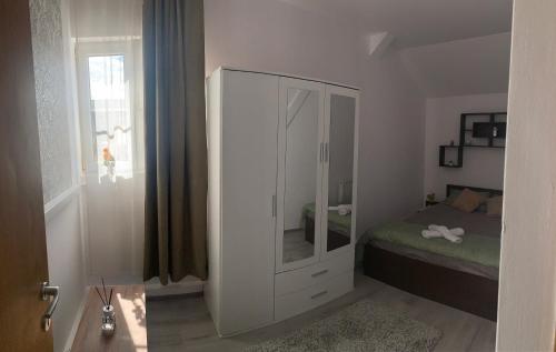 1 dormitorio con un gran armario blanco con espejo en Apartament în regim hotelier en Timisoara