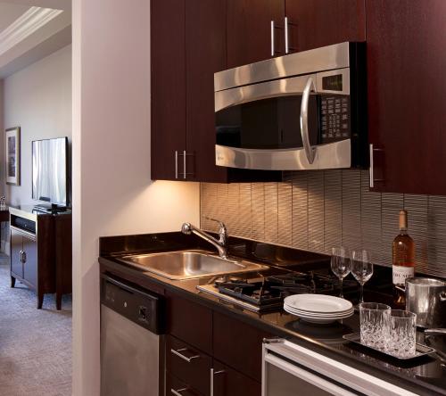 a kitchen with a sink and a microwave at Trump International New York in New York