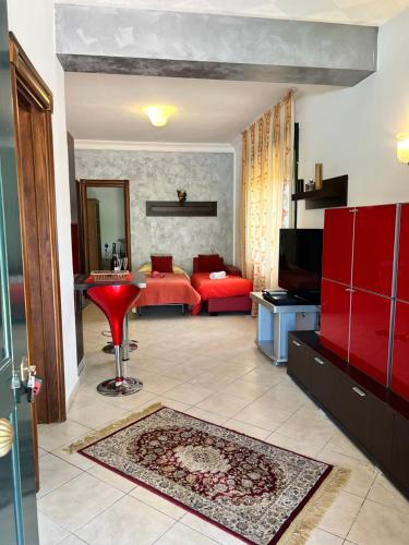 een woonkamer met rode meubels en een rode bank bij ***** La casa di Giò in Caltanissetta