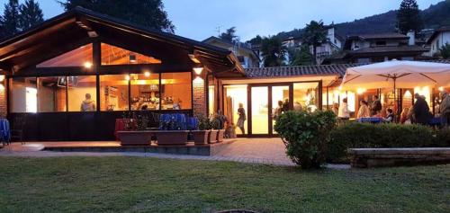 a house with people standing outside of it at night at Guesthouse Serena in Stresa