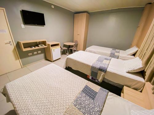 En eller flere senger på et rom på Hotel Pequeno Principe