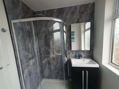 a bathroom with a shower and a sink at Mackie House by Cliftonvalley Apartments in Bristol